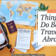 "Travel essentials for abroad: a packed suitcase, world map, passport, travel documents, and checklist representing preparation for international travel."